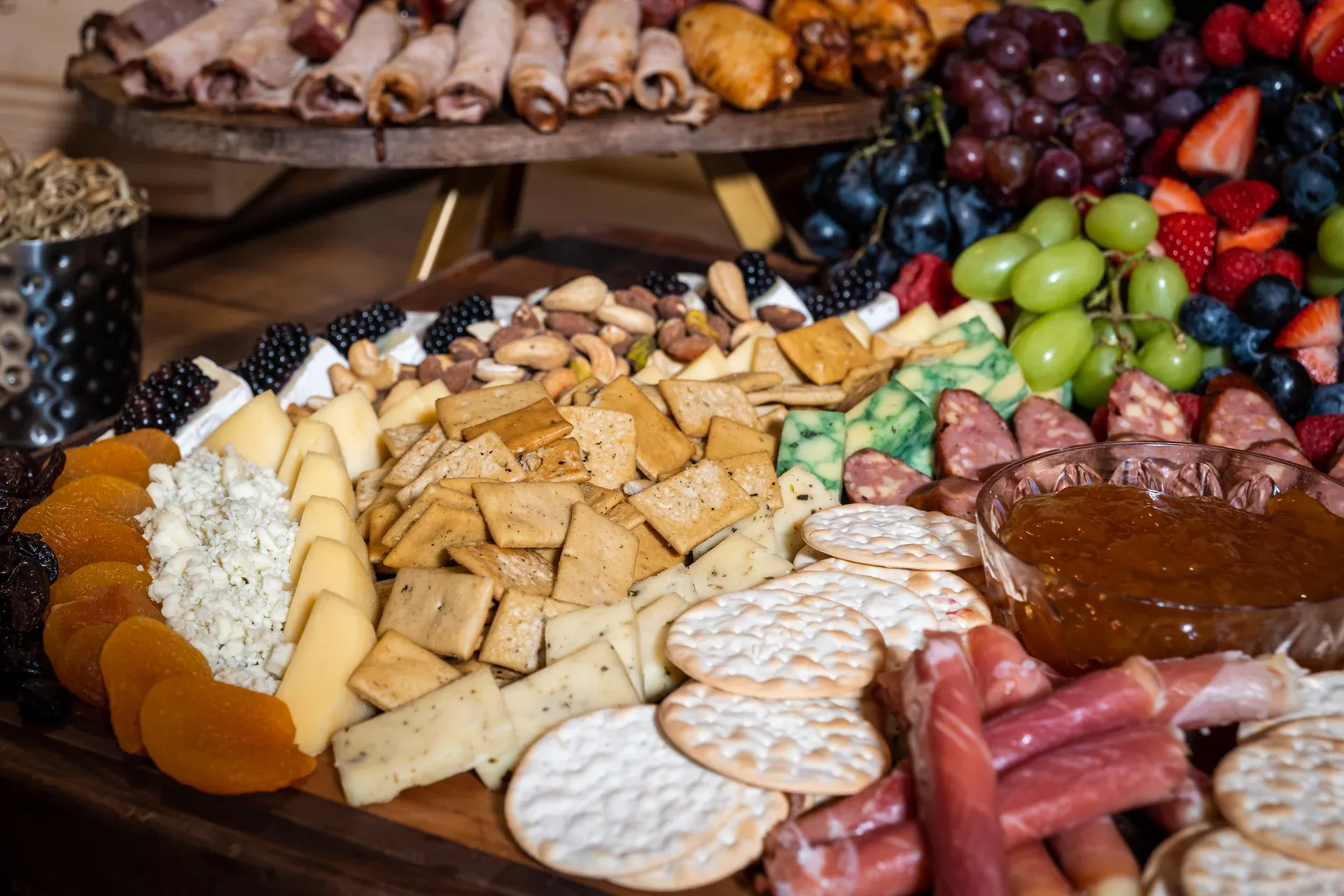 Jimmy P's catering charcuterie board with cheese, cured meats, fruits, and crackers